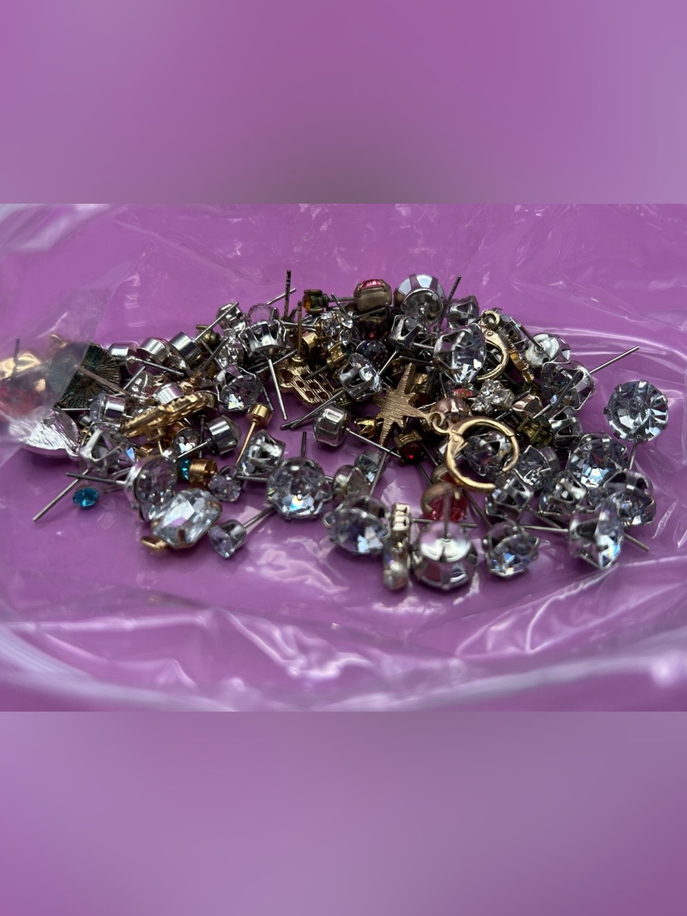 3.5 oz of rhinestone single earrings for crafting. No backings. Multi colored.